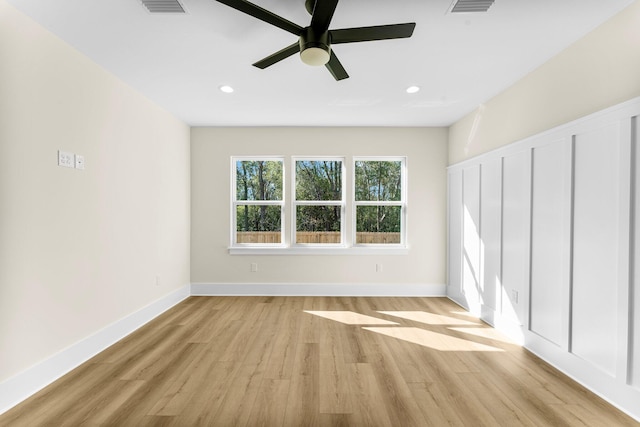 spare room featuring light wood-type flooring and ceiling fan