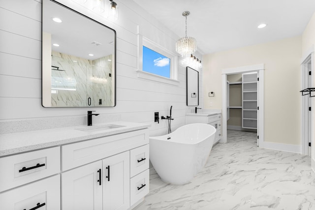 bathroom featuring vanity, wood walls, plus walk in shower, and an inviting chandelier