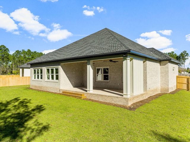 back of house with a patio area, ceiling fan, and a yard