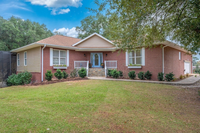 single story home featuring a porch, a garage, and a front yard