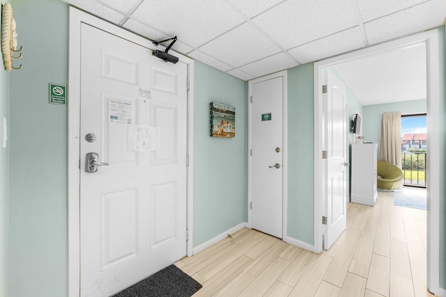 entrance foyer with a paneled ceiling and light hardwood / wood-style flooring