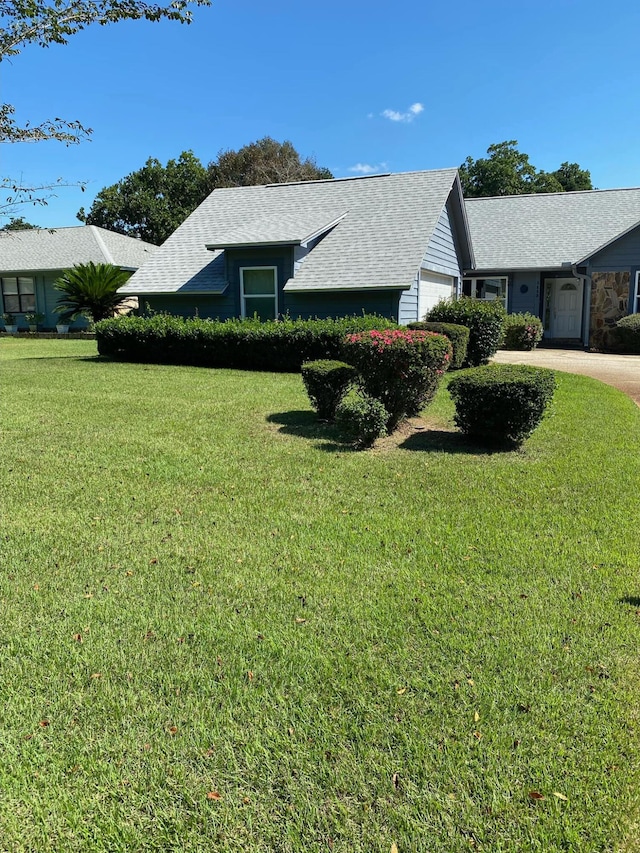 view of front of property featuring a front yard and a garage