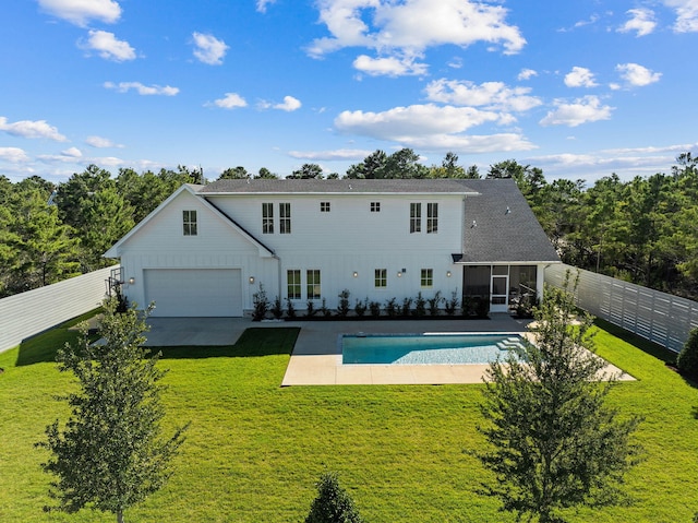 rear view of house featuring a sunroom, a patio area, and a yard