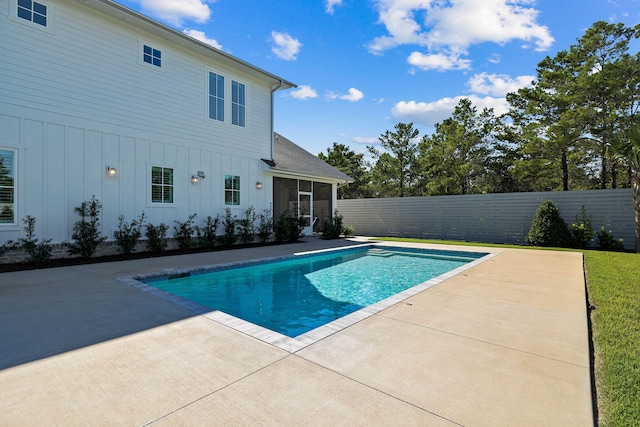 view of swimming pool with a patio area and a sunroom