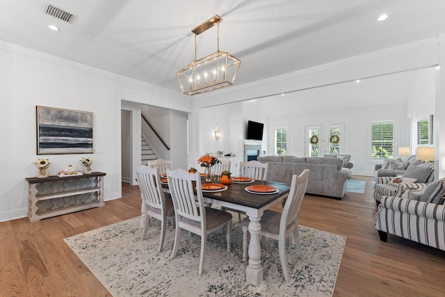 dining room with hardwood / wood-style floors and a notable chandelier