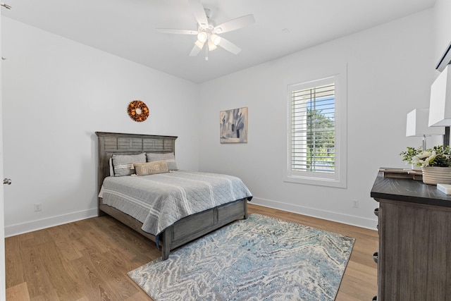 bedroom with light hardwood / wood-style flooring and ceiling fan