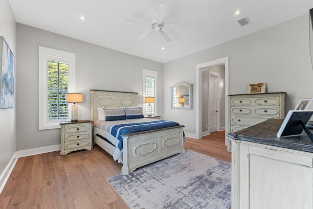 bedroom with ceiling fan and light hardwood / wood-style flooring