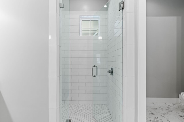 bathroom with toilet and a shower with shower door