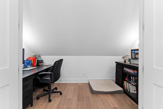 office area with light wood-type flooring and vaulted ceiling