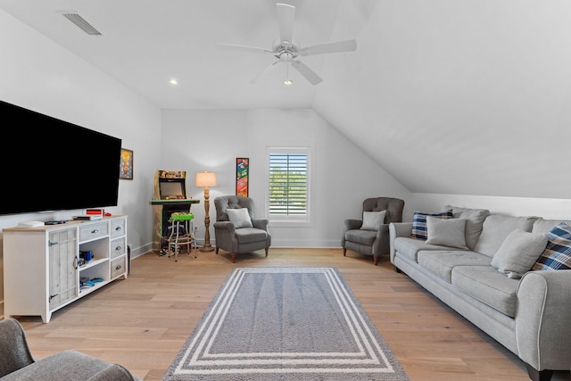 living room with light hardwood / wood-style floors, ceiling fan, and lofted ceiling