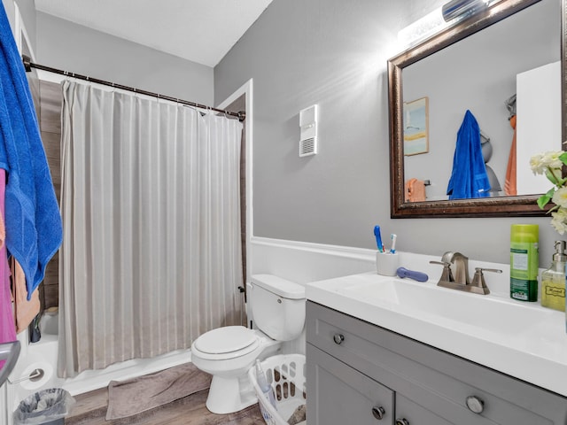 full bathroom featuring hardwood / wood-style floors, vanity, toilet, and shower / bath combo with shower curtain