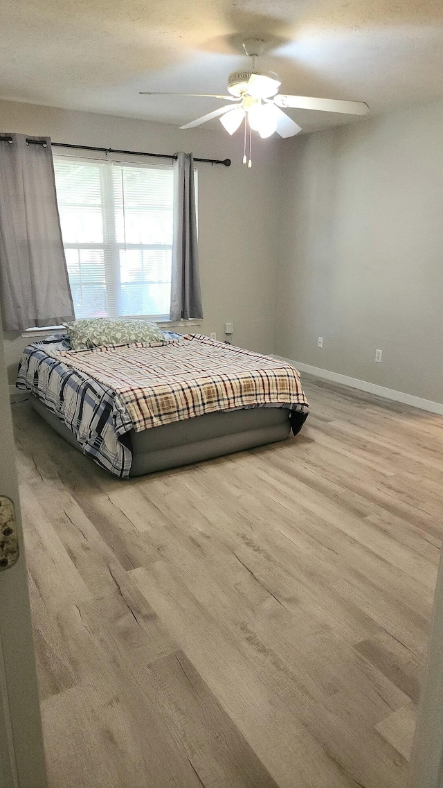 unfurnished bedroom featuring ceiling fan and wood-type flooring