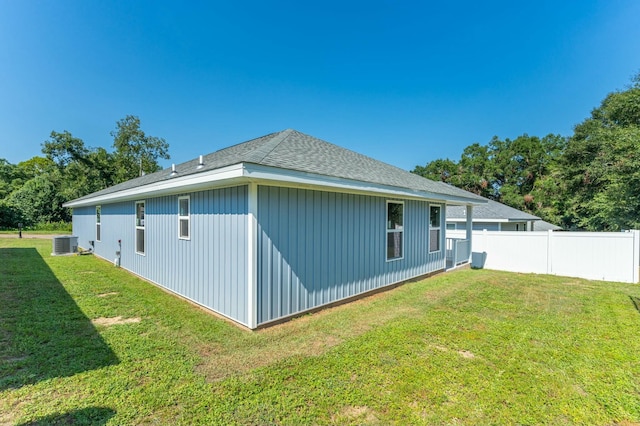 view of property exterior with a yard and central AC