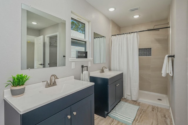 bathroom featuring vanity, hardwood / wood-style flooring, and walk in shower