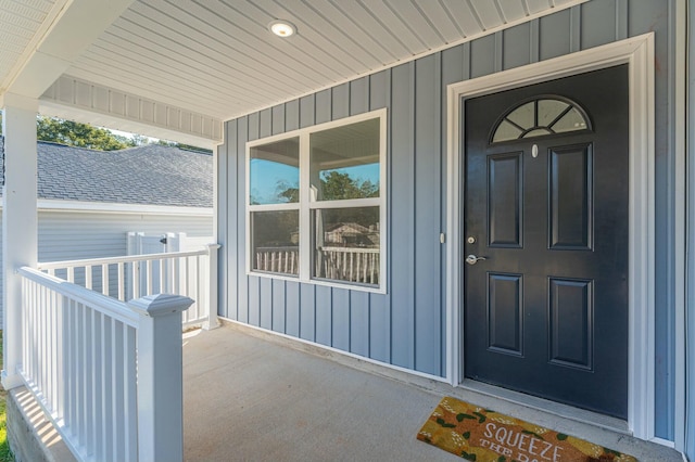 doorway to property featuring covered porch and board and batten siding