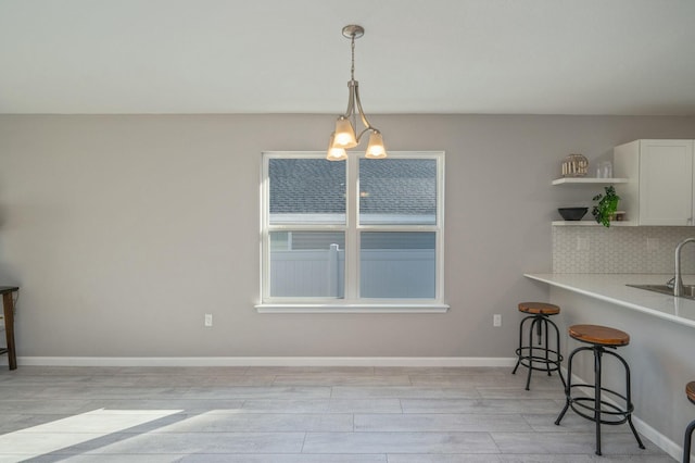 dining room with light hardwood / wood-style flooring and a chandelier