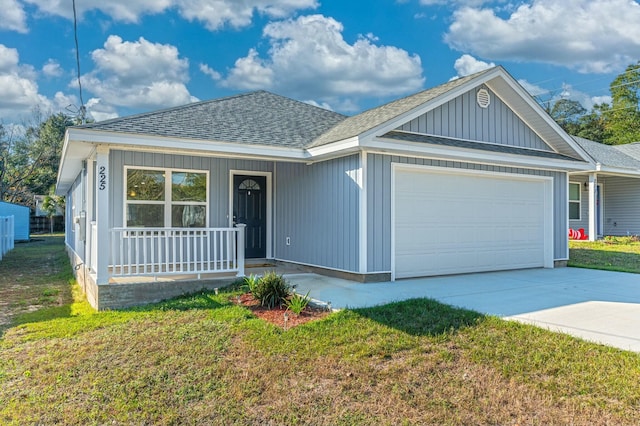 view of front facade featuring a front yard, a porch, and a garage