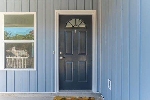 view of exterior entry with board and batten siding