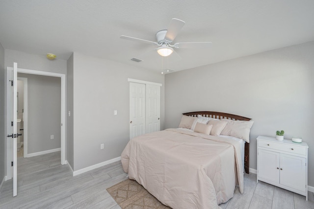 bedroom featuring a closet, ceiling fan, and light hardwood / wood-style flooring