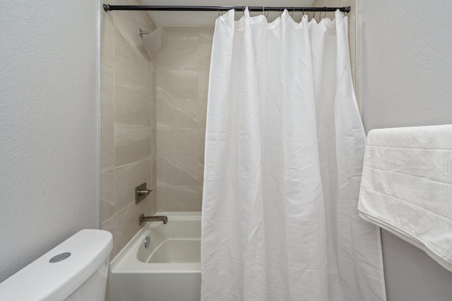 bathroom with shower / bath combo and toilet