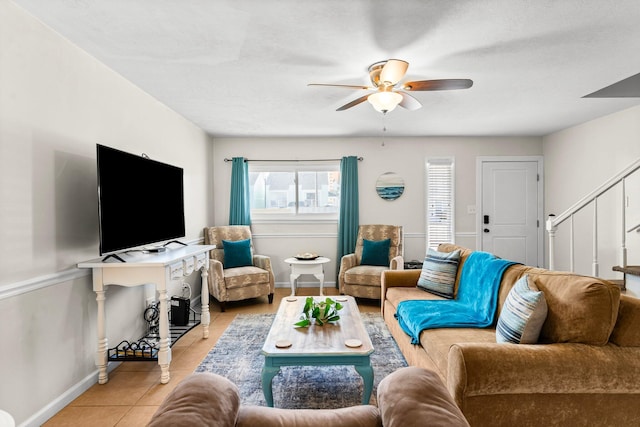 living room featuring ceiling fan and light tile patterned floors