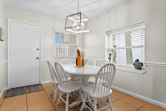 tiled dining area featuring a chandelier