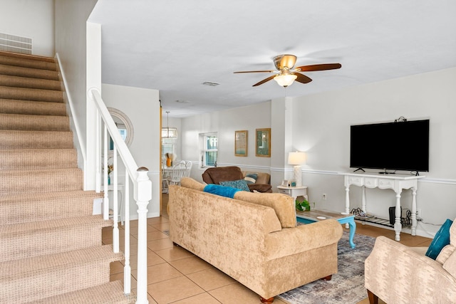 living room featuring ceiling fan and light tile patterned floors