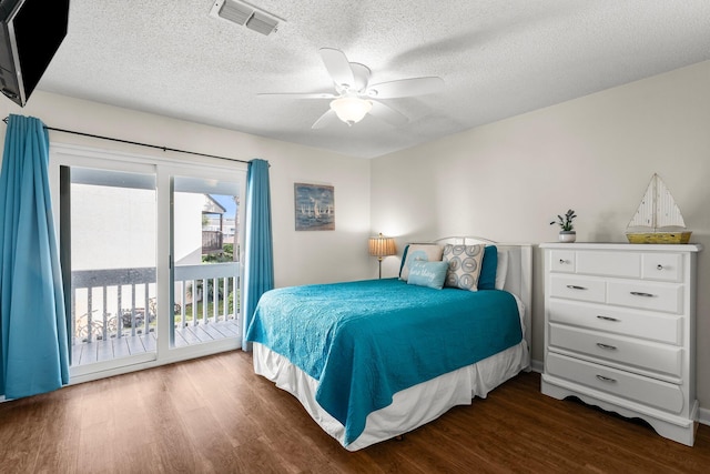 bedroom featuring access to outside, ceiling fan, a textured ceiling, and dark hardwood / wood-style floors