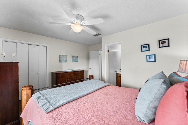 bedroom with connected bathroom, ceiling fan, a closet, and a textured ceiling