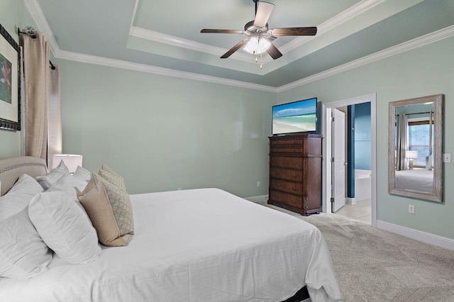 bedroom featuring ornamental molding, ensuite bathroom, ceiling fan, and light colored carpet