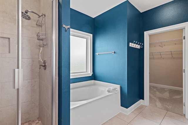 bathroom with tile patterned flooring and separate shower and tub