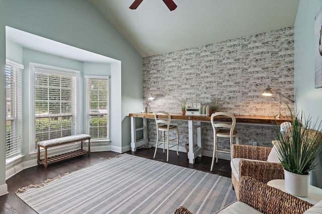 interior space with ceiling fan, high vaulted ceiling, and dark wood-type flooring