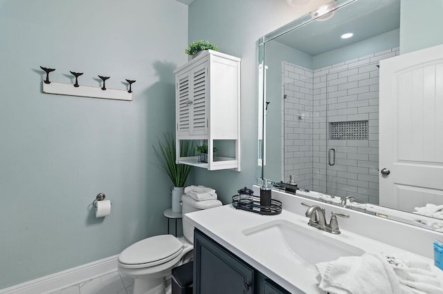 bathroom with vanity, toilet, and a shower with door