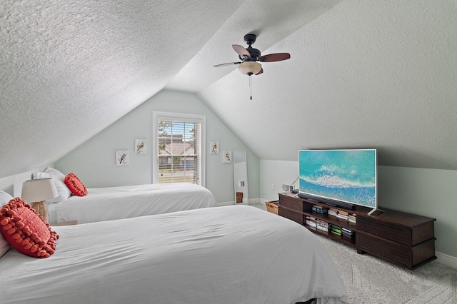 carpeted bedroom featuring ceiling fan, a textured ceiling, and vaulted ceiling