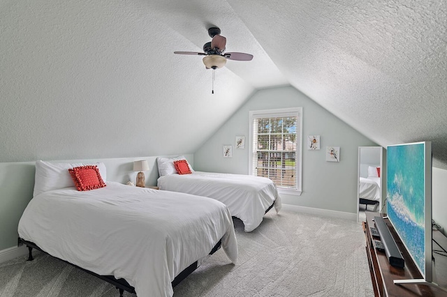 carpeted bedroom with ceiling fan, lofted ceiling, and a textured ceiling