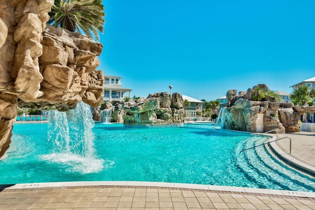 view of swimming pool featuring pool water feature