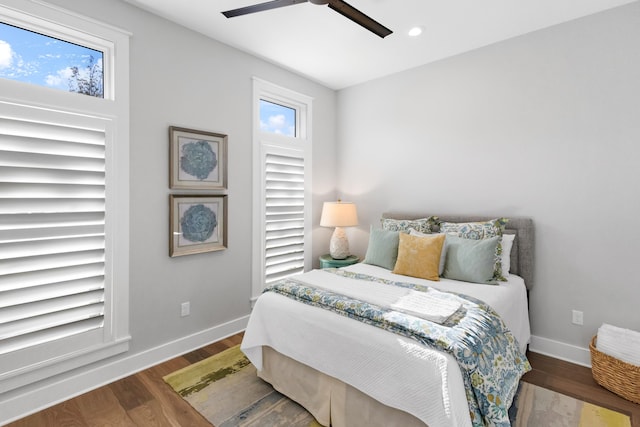 bedroom with ceiling fan and dark hardwood / wood-style flooring