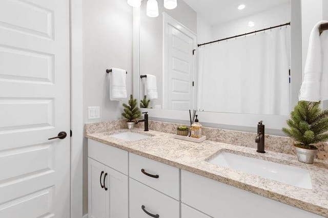 bathroom with curtained shower and vanity