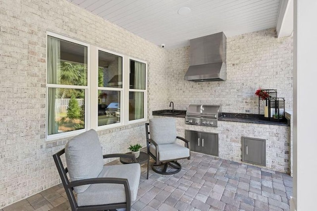 view of patio / terrace featuring a grill, sink, and exterior kitchen