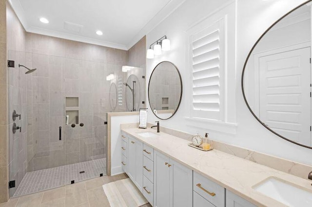 bathroom with tile patterned flooring, vanity, walk in shower, and ornamental molding