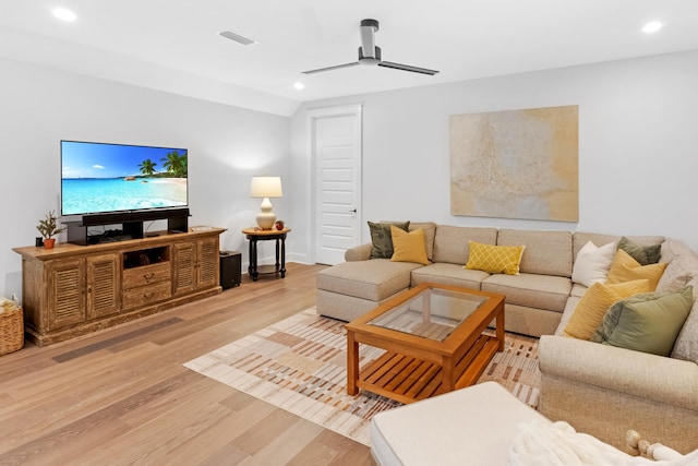 living room with ceiling fan and light wood-type flooring