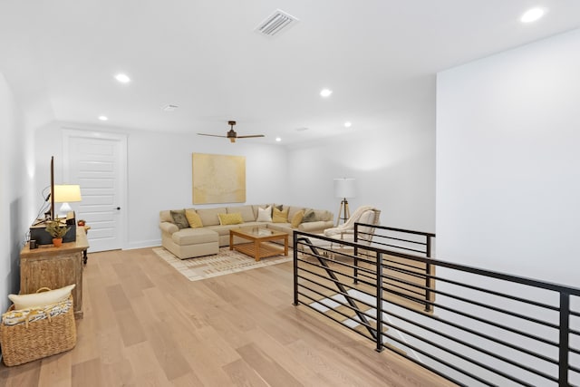 living room with ceiling fan and light wood-type flooring