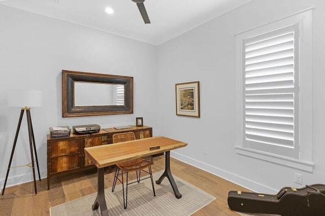 home office featuring hardwood / wood-style flooring and ceiling fan