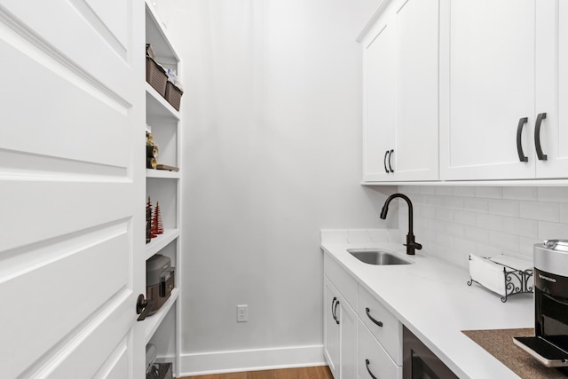 washroom with light hardwood / wood-style floors and sink