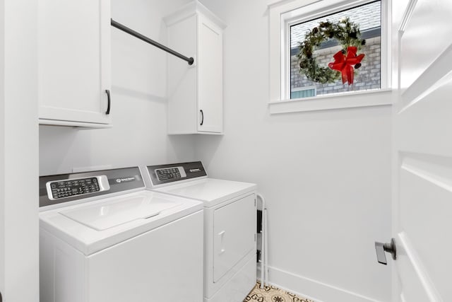 clothes washing area with cabinets and separate washer and dryer