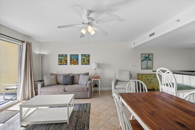 living room featuring ceiling fan and light tile patterned flooring