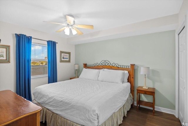 bedroom featuring ceiling fan, dark hardwood / wood-style flooring, and a closet