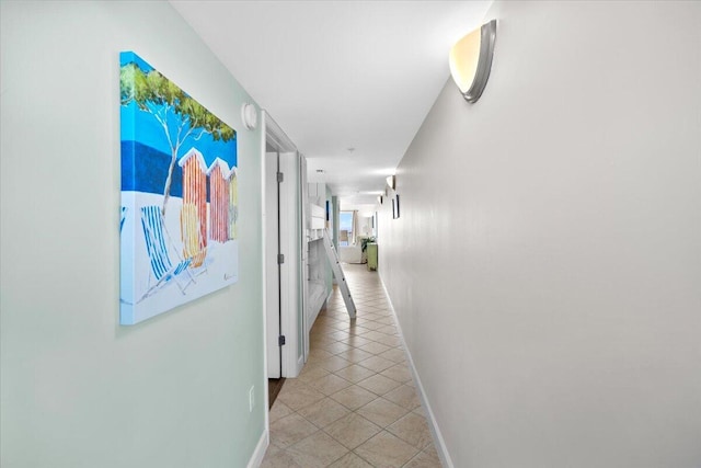 hall featuring light tile patterned floors