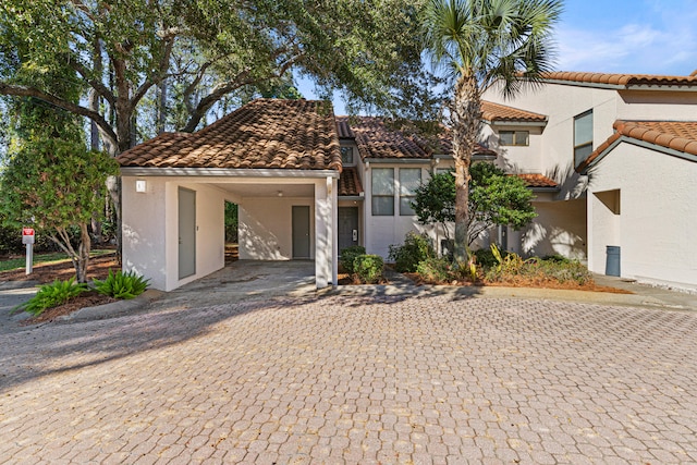 mediterranean / spanish-style home featuring a carport