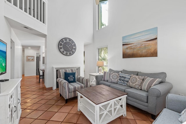 tiled living room featuring a high ceiling